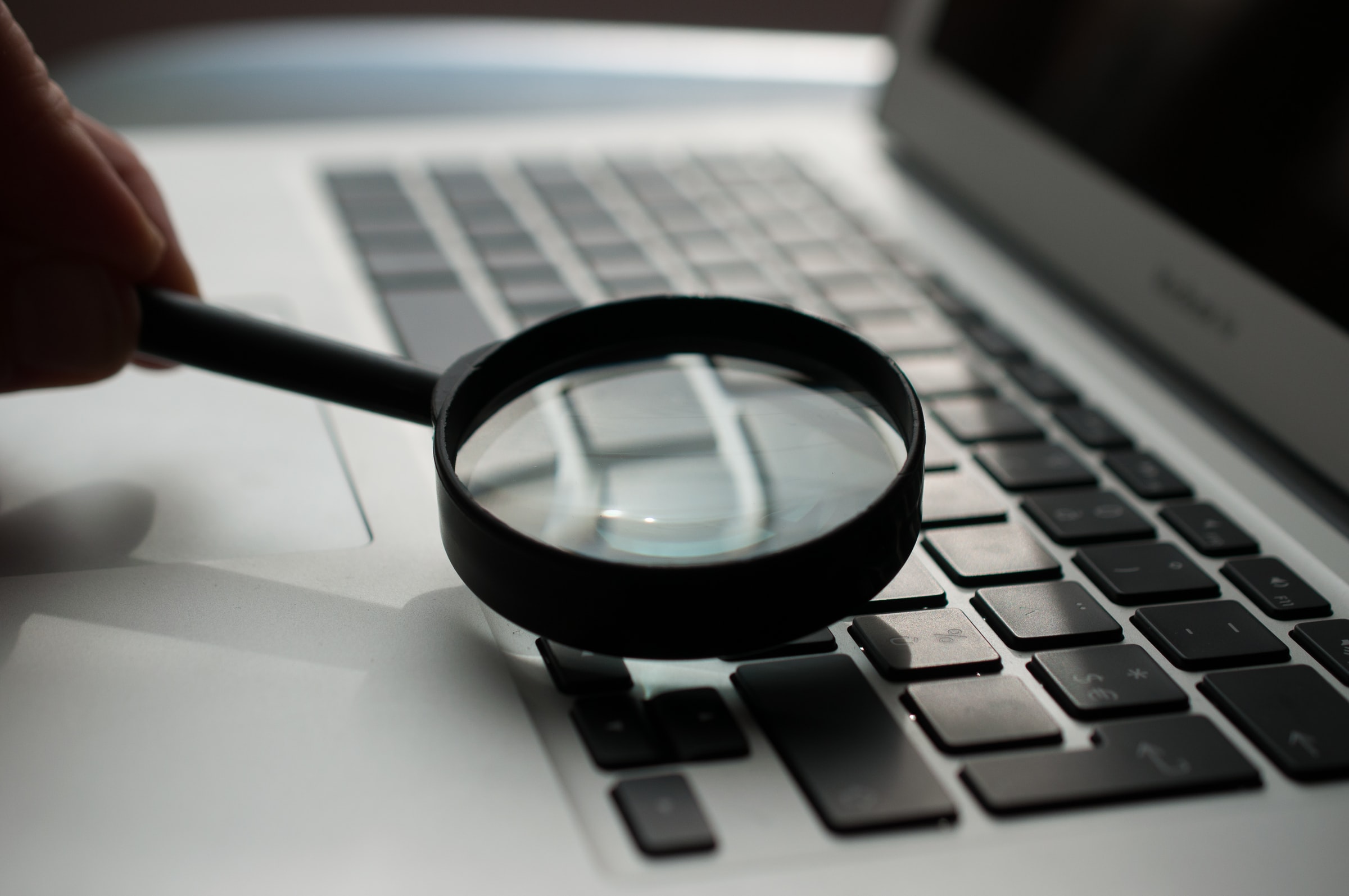 Photo of magnifying glass used on laptop keyboard